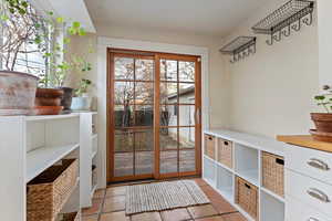 Doorway to outside featuring light tile patterned floors