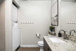 Bathroom with vanity, wood-type flooring, and toilet