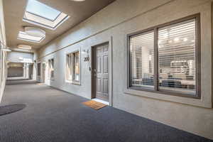 Hallway featuring carpet flooring and a skylight