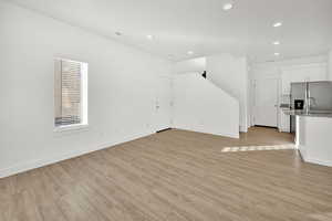 Unfurnished living room with light hardwood / wood-style flooring