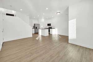 Unfurnished living room with light wood-type flooring