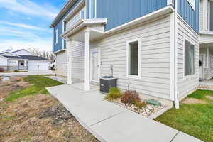 View of home's exterior featuring central AC and a yard