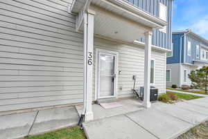 Entrance to property with central AC unit