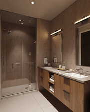 Bathroom with vanity, tile patterned floors, tile walls, and a shower with shower door