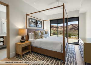 Bedroom with a mountain view, light wood-type flooring, and access to outside