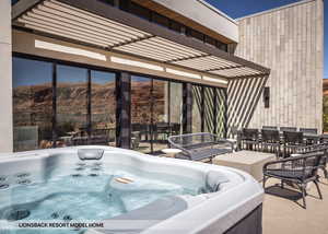 View of patio / terrace with a mountain view and a hot tub