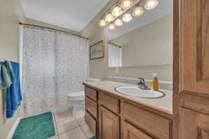 Bathroom with tile patterned flooring, vanity, and toilet