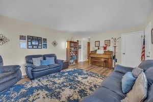 Living room with hardwood / wood-style flooring