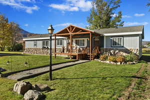 Ranch-style home featuring a front yard