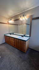 Bathroom with vanity, an enclosed shower, and a textured ceiling