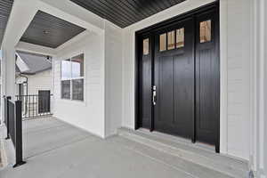 Large front porch with front door and side light details.