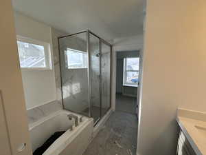 Owner's bathroom with separate soaker tub and shower.