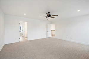 Owner's suite with ceiling fan and large windows.