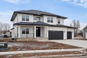 Craftsman style exterior with large front porch, 3 car garage and siding exterior.