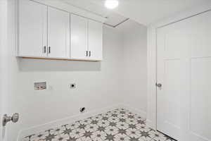 Large laundry room with cabinets for storage.