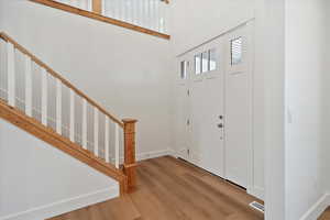 Front door entry with wood railing.