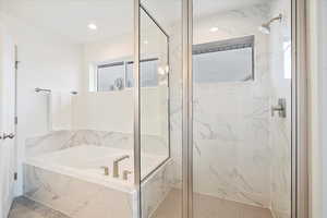 Owner's bathroom with separate tub and shower.