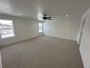 Large owner's bedroom with bedrooms wall window set and ceiling fan.