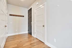 Corridor with light hardwood / wood-style floors