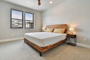 Carpeted bedroom featuring ceiling fan