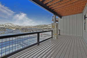 Snow covered back of property featuring a mountain view