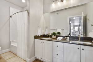 VIRTUALLY STAGED - Bathroom with vanity and shower / tub combo