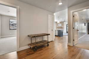 Corridor featuring hardwood / wood-style flooring