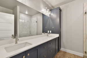 Bathroom featuring vanity, an enclosed shower, and hardwood / wood-style flooring