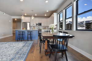 VIRTUALLY STAGED - Dining room featuring dark wood-type flooring and sink