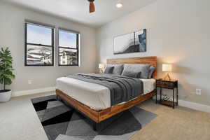 VIRTUALLY STAGED - Bedroom featuring ceiling fan and light colored carpet