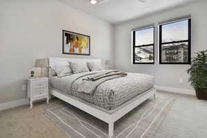 VIRTUALLY STAGED - Bedroom featuring light carpet and ceiling fan