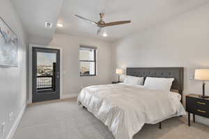 Bedroom with access to outside, ceiling fan, and light colored carpet