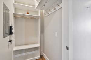 Mudroom with hardwood / wood-style floors and electric panel