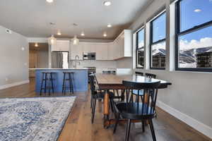 Dining area with dark hardwood / wood-style flooring and sink