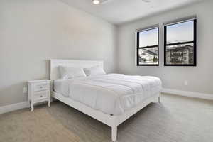 Carpeted bedroom with ceiling fan