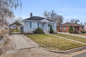 Bungalow-style house featuring a carport and a front yard