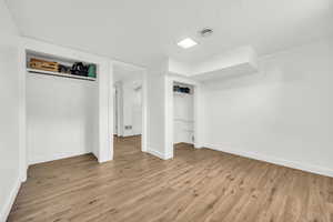 Bedroom 5 featuring a closet, hardwood / wood-style floors, and a textured ceiling