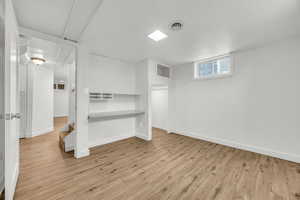 Bedroom 3 with a textured ceiling and light hardwood / wood-style flooring