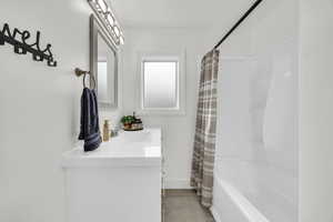 Bathroom with shower / bath combo and vanity. Main floor.