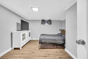 Bedroom 4 with crown molding and light wood-type flooring