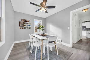 Dining room/Bedroom featuring hardwood / wood-style floors and ceiling fan.