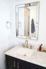 Bathroom with vanity and a shower with shower door