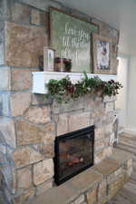 Interior details featuring hardwood / wood-style flooring and a stone fireplace