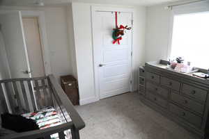 Bedroom featuring light carpet