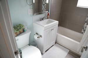 Full bathroom with toilet, vanity, shower / bath combination with curtain, and hardwood / wood-style flooring