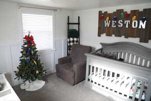 Bedroom with carpet flooring and a nursery area