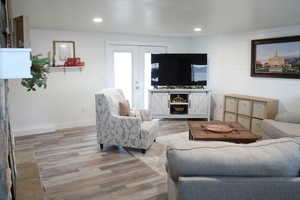 Living room featuring french doors and light wood-type flooring