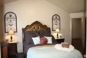 Master Bedroom featuring dark wood-type flooring and vaulted ceiling