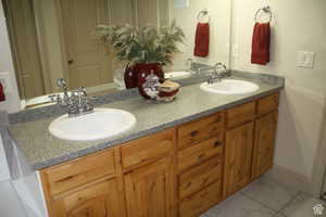 Master Bathroom with tile patterned flooring and vanity