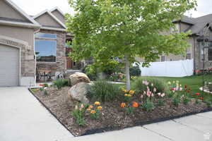 Exterior space featuring a front lawn, a patio, and a garage